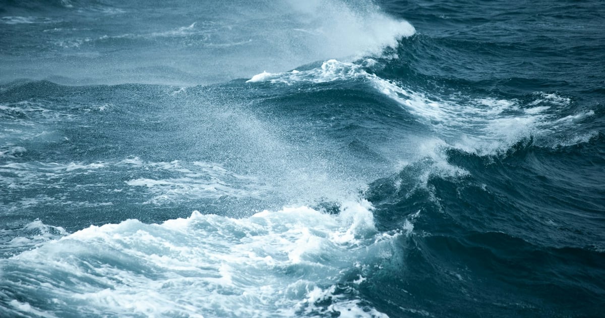 Rough dark-blue sea with breaking waves and white foam